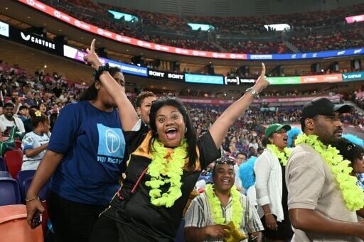Fiji fans cheer their team at the Kai Tak sports stadium