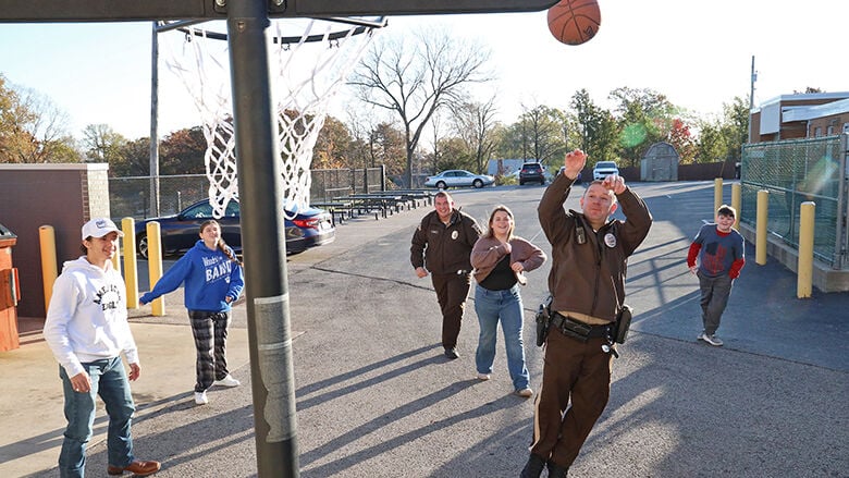 Jefferson County Sheriff’s Office Deputy Andrew Dennis, a school resource officer for the Northwest School District, plays basketball with students. Dennis graduated from Northwest High School in 2008.