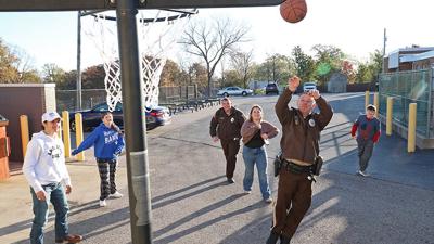 Jefferson County Sheriff’s Office Deputy Andrew Dennis, a school resource officer for the Northwest School District, plays basketball with students. Dennis graduated from Northwest High School in 2008.