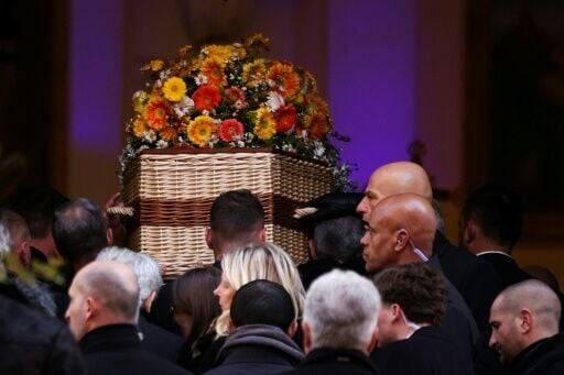 Pall-bearers carry Bardot's coffin into the Notre-Dame de l'Assomption church