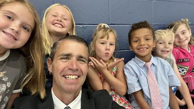 Murphy Elementary School Principal Ernest Motley takes a selfie with several students.