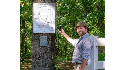 Ryan Hurtgen scans the QR code for the scavenger hunt on the Discovery Trail.