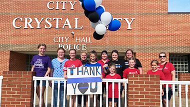 Volunteers with the 10-4 Project drop off gift cards and snacks for Crystal City Police and dispatchers.