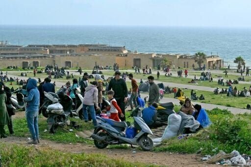 People who fled Beirut's southern suburbs after the latest Israeli bombing warning take refuge by a beach
