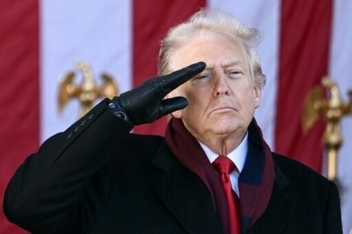 US President Donald Trump salutes at the conclusion of a Veterans Day ceremony at Arlington National Cemetery in Arlington, Virginia on November 11, 2025.