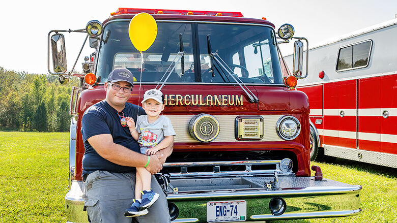 Michael Wittu, volunteer firefighter for Cedar Hill and Herculaneum, and his son, Elijah, 3, of De Soto, attend the 29th annual Fire Engine Rally.