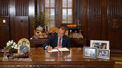 Gov. Mike Kehoe on June 30 signs the state budget.
