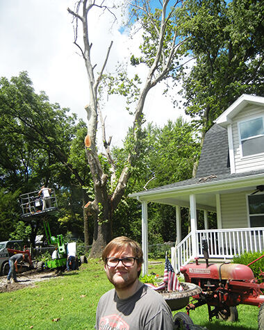 Mike Sievers of Festus with the approximately 100-year-old sycamore on his property that had died and needed to be cut down.