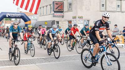 Main Street in Festus is covered with cyclists as the 2023 Bottleneck Bridge Ride begins.