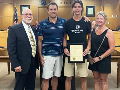 Jacob Meyers is presented with an award by Mayor Sam Richards at the June 27 city council meeting.