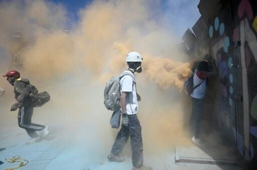 Police protecting the compound used tear gas grenades and fire extinguishers to contain the protesters