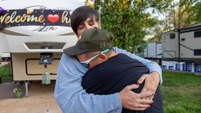 Dan Cothern and Danielle Gherardini embrace outside his new home.