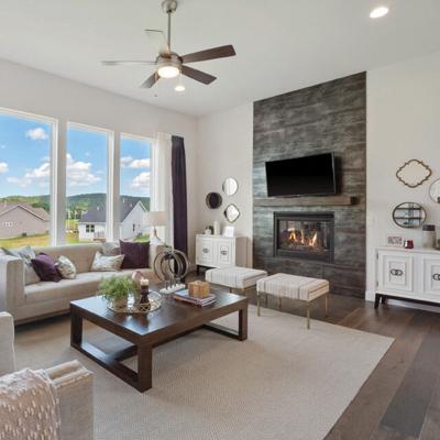 This Eureka home features a great room with a window wall and direct vent fireplace with a stone surround.