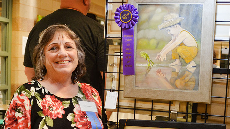 Lori Herres of Hillsboro by her Best of Show oil painting titled “Hippity Hoppity.”