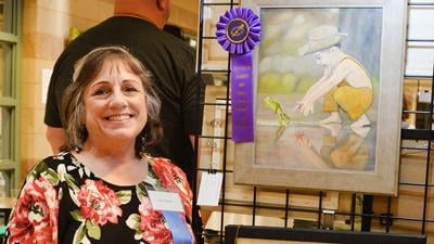 Lori Herres of Hillsboro by her Best of Show oil painting titled “Hippity Hoppity.”