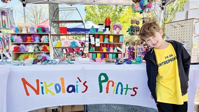 Nikolai, 6, sells wares, which he 3D printed, at a CEM in Georgia.