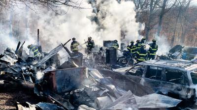 Crews from the High Ridge, Eureka, Saline Valley, Goldman and Cedar fire protection districts worked to put out a fire that destroyed a House Springs garage and these three vehicles.
