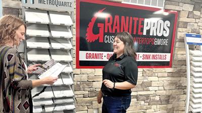 Granite Pros project manager Jamie Brown, right, looks over samples with an office manager in the company’s Imperial showroom.