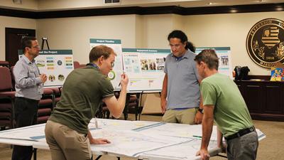 Public Works employees and draft design consultants speak to residents at an open house in October.
