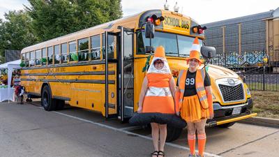 Sisters Briget James and Shi Haws of De Soto are bus drivers for De Soto School District and came to the annual De Soto Fall Festival in traffic cone costumes.