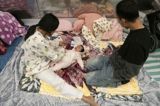 A family with a two-month-old child takes shelter in a train station in Tel Aviv during an ongoing rocket attacks from Iran in response to a US-Israeli attack