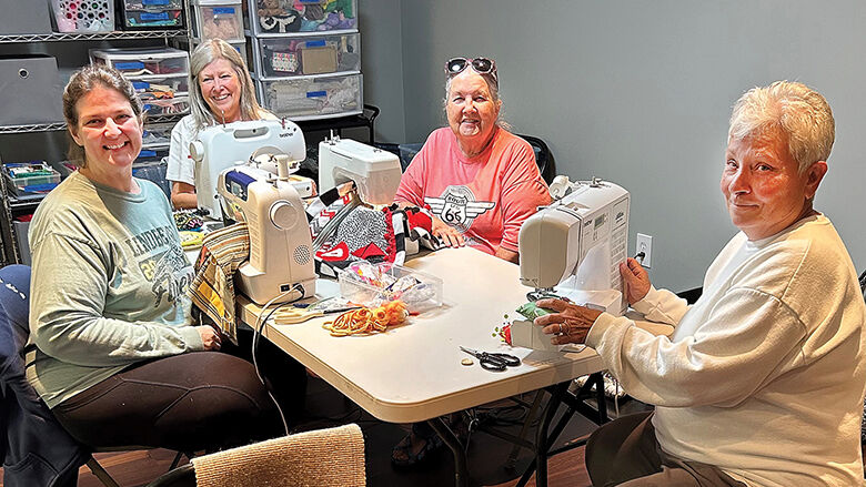 From left, Emily Cook, Kim Whatley, Sharon Miller and Agnes Nichols work on sewing fidget mats designed for use by patients with Alzheimer’s or dementia.