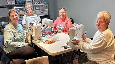 From left, Emily Cook, Kim Whatley, Sharon Miller and Agnes Nichols work on sewing fidget mats designed for use by patients with Alzheimer’s or dementia.