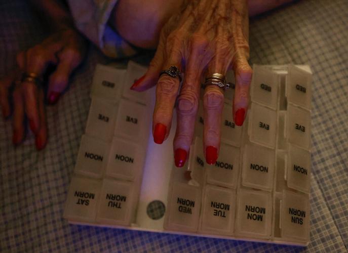 Malden Pharmacy patient Dorothy White looks over her weekly pill box
