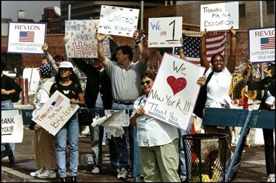 People cheer rescue workers on their way to the site of the 9/11 terror attacks in New York. After major disasters, people often extend help beyond their social circles, crossing political, socioeconomic and religious divides.