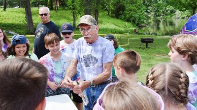 David Tidd shows off a fish to a group of Rockport Heights Elementary students.