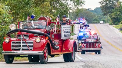 Grand Marshal Glenn Nivens, retired fire marshal from the Antonia Fire Protection District, leads the 2019 Jeffco Fire Engine Rally parade into Herculaneum Park.