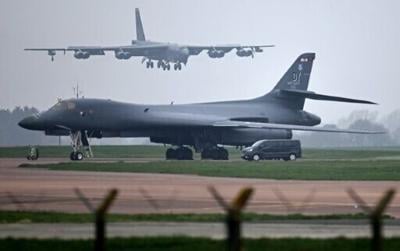 A US Air Force Boeing B-52 Stratofortress bomber jet lands on the runway, beyond a USAF Rockwell B-1 Lancer bomber jet, at RAF Fairford in south west England on March 9, 2026.