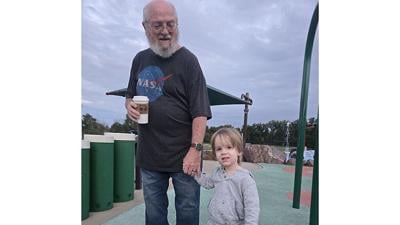 Arthur Freeman, 2, enjoys the park with his grandfather, Robert Freeman.