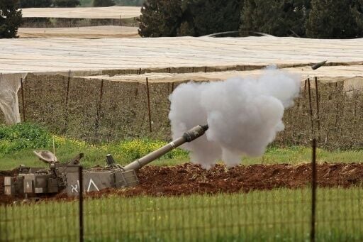 An Israeli self-propelled howitzer artillery gun fires rounds towards the southern Lebanon