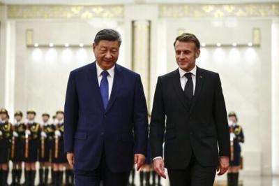 China's President Xi Jinping (L) and France's President Emmanuel Macron attend a welcome ceremony at the Great Hall of the People in Beijing on December 4, 2025