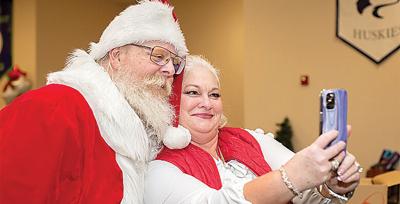 Fox C-6 assistant superintendent Tammy Cardona takes time for a selfie with the Jolly Old Elf at last year’s event.
