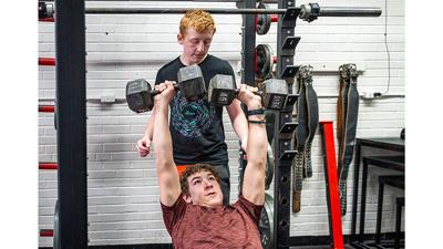 Crystal City freshman Connor Calhoun, 15, spots junior Jonathan Tipton, 16.