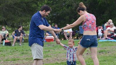 Alex Schwent, left, Alexander Schwent Jr., 23 months, and Kristen Schwent, all of Festus, enjoy the music June 11 at the Swingin’ Under the Stars concert at Larry G. Crites Memorial Park in Festus.