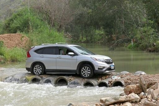 Displaced people drive back to their homes across the Litani river in southern Lebanon