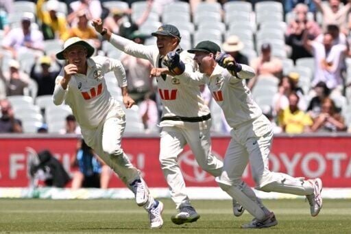 Australia's Marnus Labuschagne (L), Usman Khawaja (C) and Alex Carey (R) celebrate after Lasuchagne caught Josh Tongue to seal the Ashes
