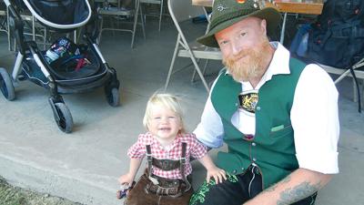 Neal Thompson and his son, Jaxon, 19 months, wear German garb at the German Cultural Society’s Maifest held this past weekend in House Springs.