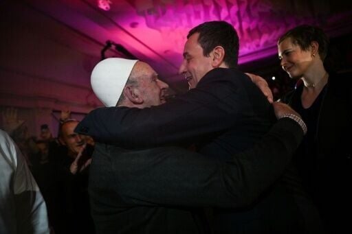 Kurti (R) embraces a supporter during a campaign rally in Podujevo