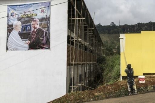 A poster portraying Pope Leo XIV (L) and Archbishop of Bamenda Andrew Nkea (R) at the Saint Joseph Metropolitan Cathedral
