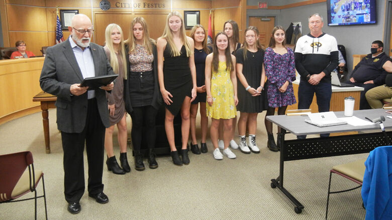 The Festus High girls team receives its proclamation from Festus Mayor Sam Richards (at far left). Head coach Bryant Wright is at far right.