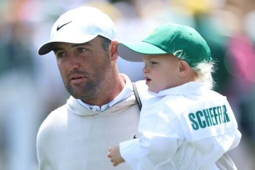 Top-ranked Scottie Scheffler, a four-time major winner from the United States, carries his son Bennett during the Masters Par-Three Contest at Augusta National