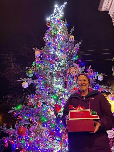 Patsy Westhoff flips the switch for the Christmas tree at De Soto City Hall.