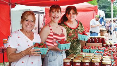Imperial Produce Market co-owner Chris Leach, left, (with husband Don Leach, not shown) shows off some of her strawberry wares with granddaughter Grace Mueller and sister Gina Viviano at last year's Strawberry Festival.
