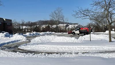 Fox C-6 School District employees on Jan. 9 clear snow and ice from the Fox campus, which has a high, middle and elementary school, in Arnold.