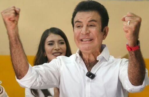 Honduran presidential candidate Salvador Nasralla of the opposition Liberal Party gestures alongside his wife Iroshka Elvir after casting his vote