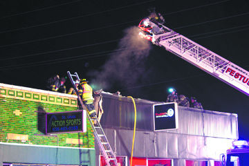 Firefighters work to put out a blaze at Thirty 3 Bar & Grill in Festus